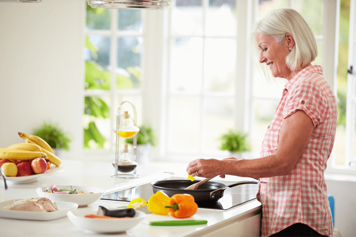 Midlife Woman Eating Healthy Midlife woman preparing a healthy meal