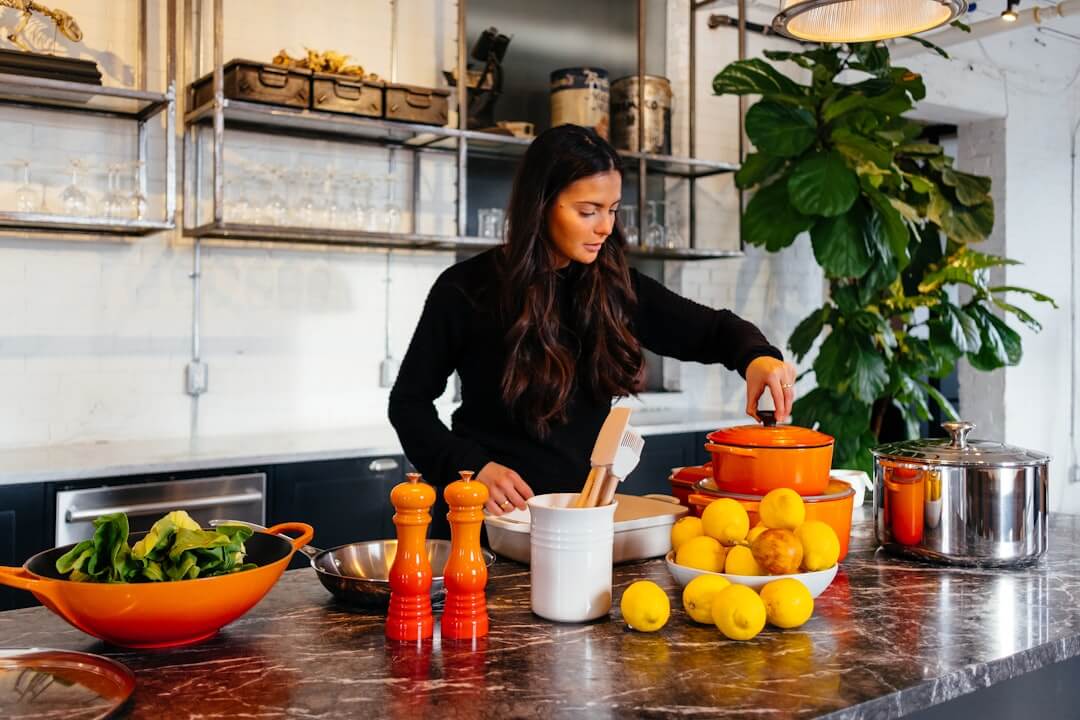 Woman preparing a meal in a home kitchen with fresh ingredients